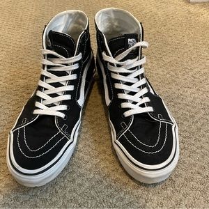 Black and white high top vans